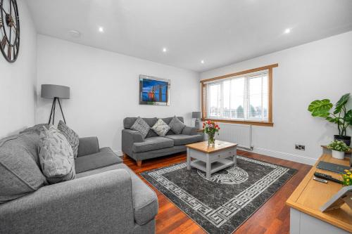 a living room with a couch and a table at Leys Park Executive Apartments in Dunfermline