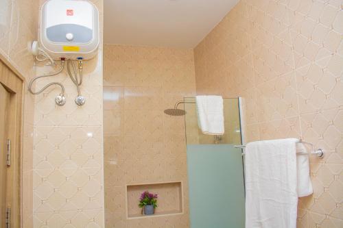 a bathroom with a shower and a toilet and a towel at House 24 Jahi in Kadobunkuro
