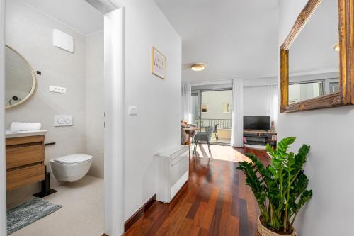 a bathroom with a toilet and a sink and a mirror at Vila Pivac in Makarska