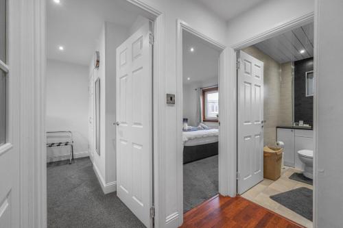 a room with a bathroom with a bed and a toilet at Leys Park Executive Apartments in Dunfermline