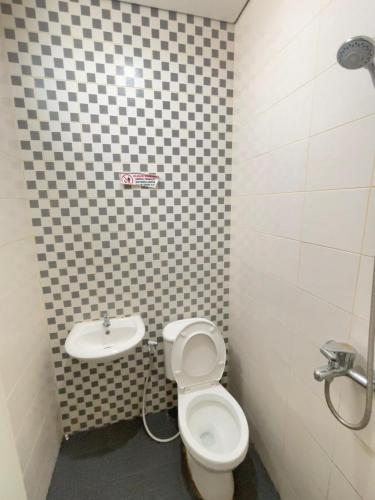 a bathroom with a toilet and a sink at Sentul Inn in Citaringgul 1