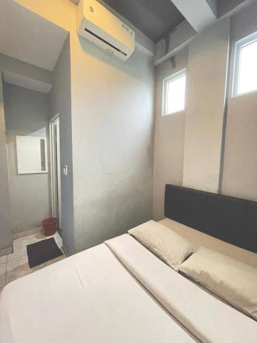 a bedroom with a bed and a air conditioner at Sentul Inn in Citaringgul 1