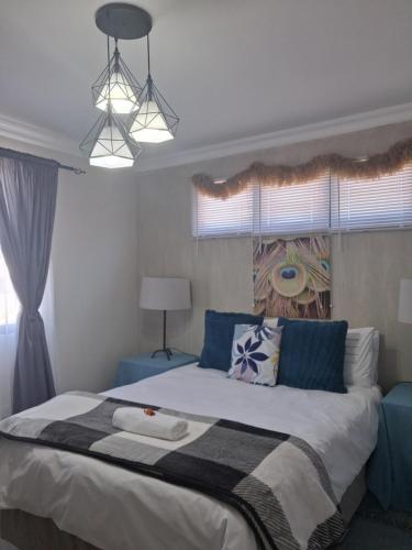 a bedroom with a large bed and a window at Bedrock Accommodation in Gansbaai