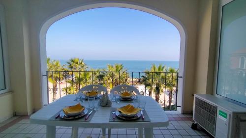 a table in a room with a view of the ocean at Trilocale DIRETTAMENTE SUL MARE CON DUE BAGNI cod 510 in Porto Recanati