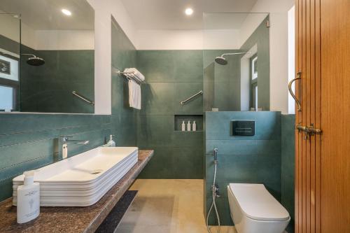 a bathroom with a sink and a toilet at SaffronStays Casa Amore in Mahabaleshwar