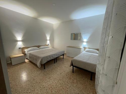 a bedroom with two beds and a mirror at Rifugio Urbano in Terni
