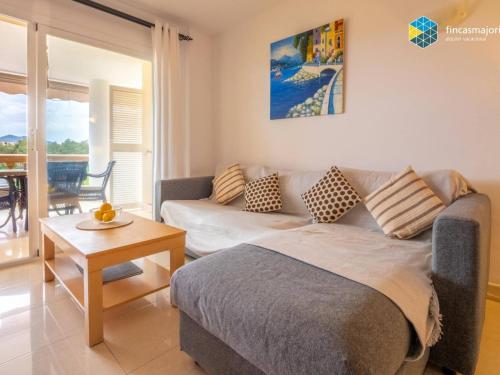 a living room with a bed and a couch at Apartamento Rosa in Cala Bona