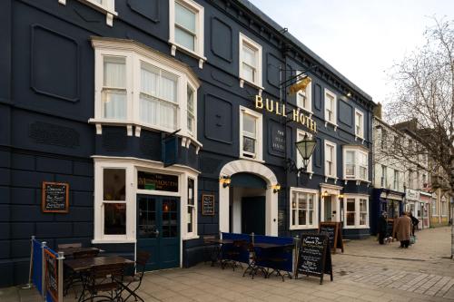a blue building with a table outside of it at The Bull Hotel in Bridport