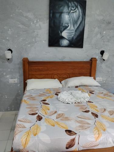 a bedroom with a bed with leaves on it at POLE-INN VILLA Nungwi Zanzibar in Nungwi