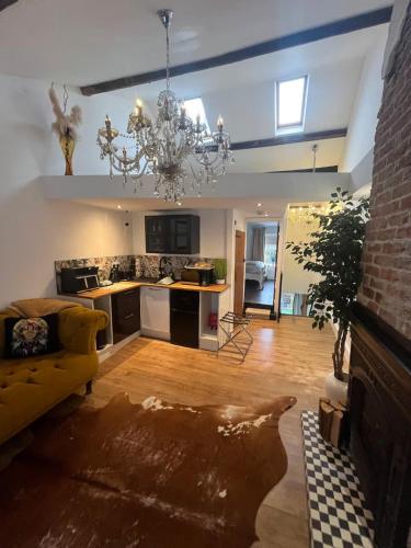 a kitchen and living room with a chandelier at Rooftop One-Bedroom Apartment Near East Midlands Airport in Castle Donington