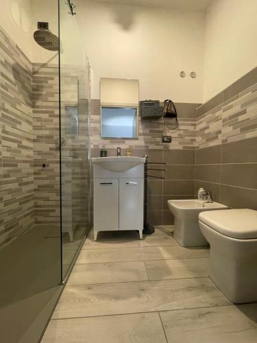 a bathroom with a sink and a toilet and a shower at Rifugio Urbano in Terni