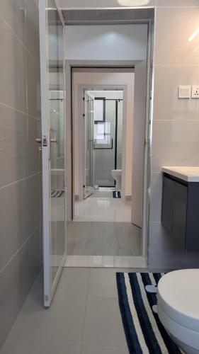 a bathroom with a toilet and a shower and a sink at Oceania Suites 5 Minutes from Jomo Kenyatta international Airport in Nairobi