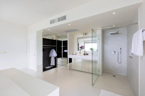 a white bathroom with a shower and a sink at Villa Danisa 4BR Panoramic Ocean View with Infinity Pool & Private Gym in Choeng Mon Beach