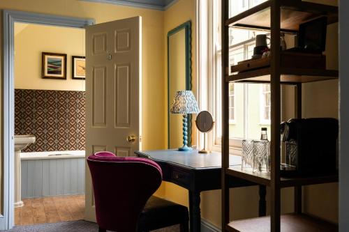 a home office with a desk and a chair at The Bull Hotel in Bridport