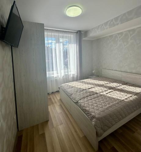 a bedroom with a bed and a large window at Апартаменти Пасаж 2 in Skhidnitsa