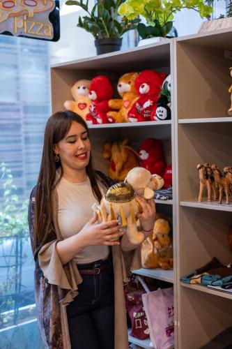 a woman standing in front of a shelf of stuffed animals at Grand Kingsgate Jaddaf Waterfront Hotel by Millennium in Dubai