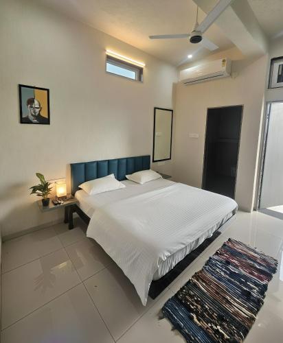 a bedroom with a large white bed in a room at Hotel Blueberry Bhedaghat in Jabalpur