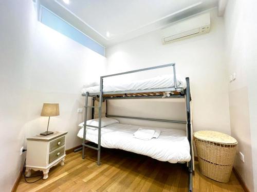 a bedroom with a bunk bed and a night stand at Alassio bnb Apartments in Alassio