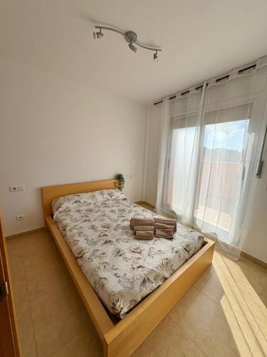 a bedroom with a bed with two towels on it at Apartament Deportiva in Deltebre