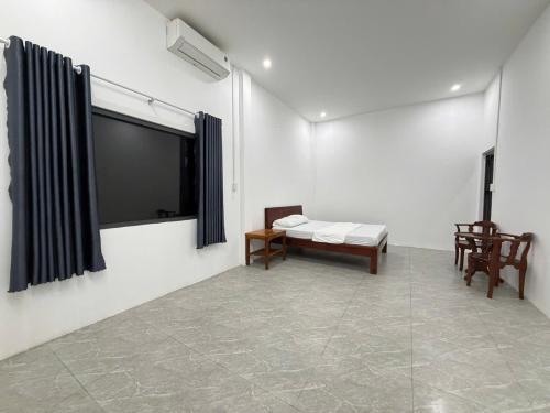 a living room with a flat screen tv on a wall at Ocean Bungalow in Phú Quốc