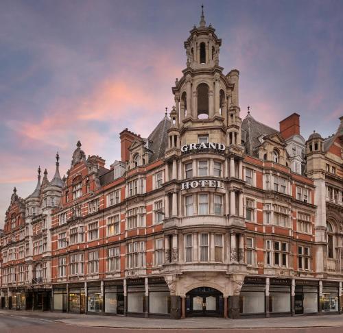 a large building with a clock tower on top of it at The Grand Hotel Leicester by The Unlimited Collection in Leicester