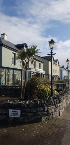 a street light and some houses and palm trees at Surfers Getaway - Room Staycation in Sligo