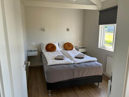 a bedroom with a bed with towels on it at Mountain Cabin at Rauðafell in Hvolsvöllur