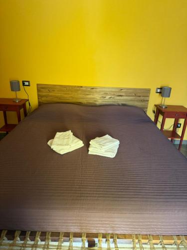 a bed with two towels sitting on top of it at Casa Gio in Lesa