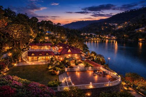 an aerial view of a resort on a lake at night at Neelesh Inn - Luxury Lake View Resort with Swimming Pool on Bhimtal Lake in Bhīm Tāl