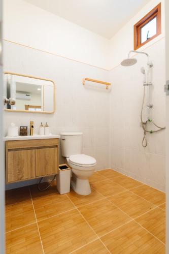 a bathroom with a toilet and a sink and a shower at Tenki poolvilla srisaket in Ban Phia Nam