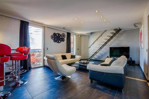 a living room with couches and chairs and a staircase at RG Duplex - Sea View - Palais & Croisette - Luxury Stay by LRA Cannes in Cannes