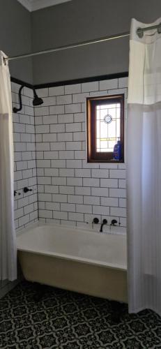 a bath tub in a bathroom with a window at Himmel Haus in Laguna
