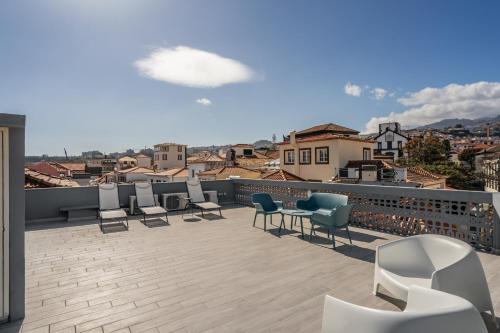 a patio with chairs and a table on a roof at Queimada Lodges by An Island Apart in Funchal