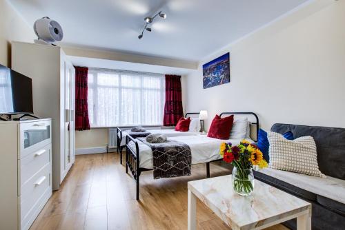 a living room with a bed and a couch at Smart Studio- North London - Sleeps 2 - free parking in London