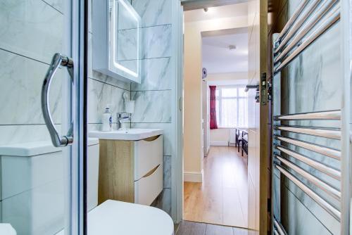 a bathroom with a sink and a shower at Smart Studio- North London - Sleeps 2 - free parking in London