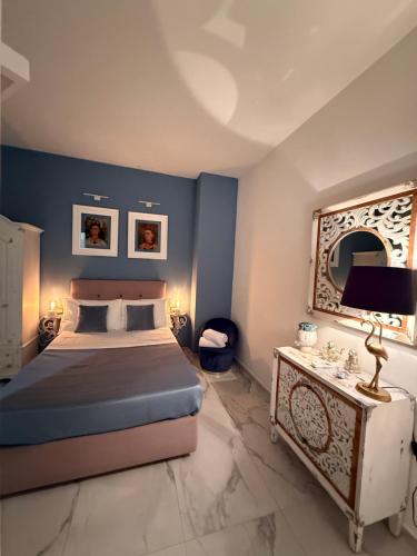 a bedroom with a bed and a mirror on the wall at Frida Kahlo appartament in Lacco Ameno