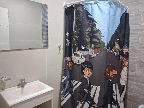 a bathroom with a shower curtain in a bathroom at Lenn Rem Eze in Ezeiza