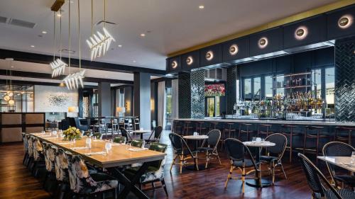 a restaurant with tables and chairs and a bar at Crowne Plaza North Augusta, by IHG in North Augusta