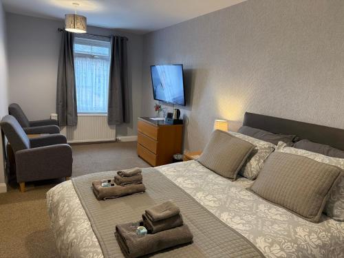 a bedroom with a bed and a chair and a television at YO10 in York