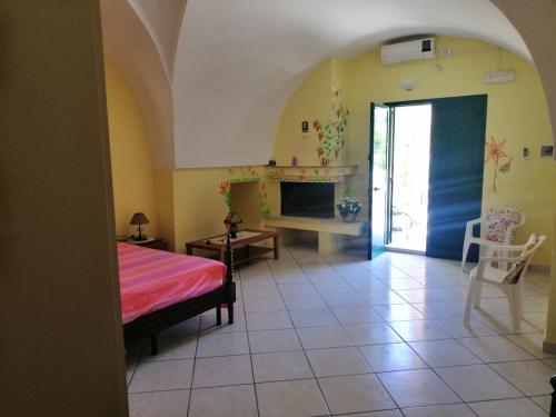 a bedroom with a bed and a fireplace at TeNuTa Li Frasulli in Sannicola