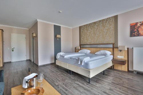a bedroom with a large bed and a table at M13 Hotel in Riol