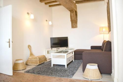 a living room with a couch and a tv at Les Soeurs · Vue cathédrale · Chartres centre in Chartres