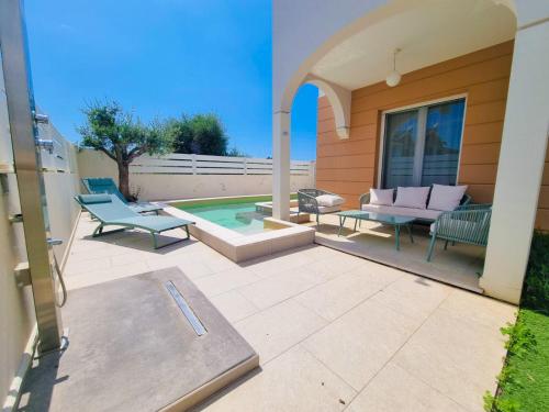 a patio with two chairs and a pool at Calypso Luxury Pool&Spa in Pula