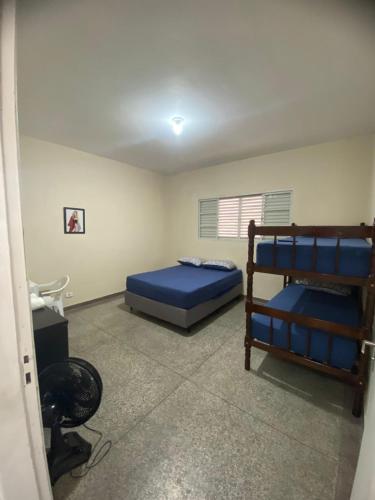 a bedroom with two bunk beds and a television at FIRMH HOSTEL CAFE DA MANHA incluso e traslado in Guarulhos