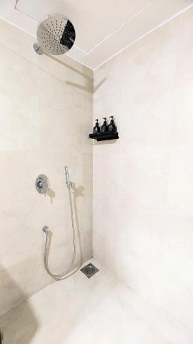a bathroom with a shower with a shower head at Monochrome County 16th floor in Dehu Road