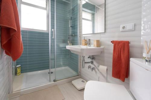 a bathroom with a shower and a sink and a toilet at Playa Anaconda - Wellhome Alicante in Benimagrell