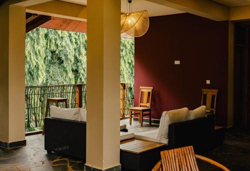 a living room with a view of a balcony at Explorers Kilimanjaro Boutique Hotel in Moshi