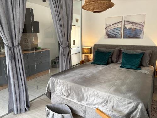a bedroom with a large bed with blue pillows at Villa TerraAurora in Barbat na Rabu