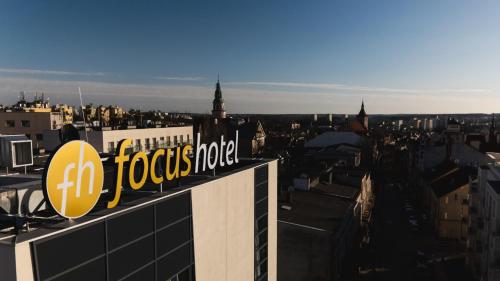 a building with a foxoco hotel sign on top of it at Focus Hotel Premium Olsztyn in Olsztyn