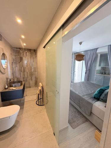 a bathroom with a shower and a bed and a tub at Villa TerraAurora in Barbat na Rabu